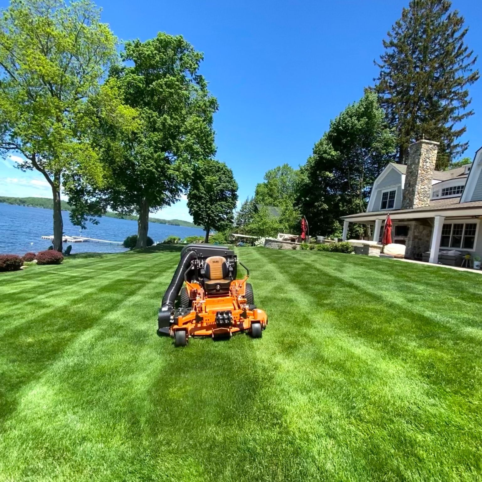 lawn care program on a waterfront lawn with a commercial mower and strong green striping